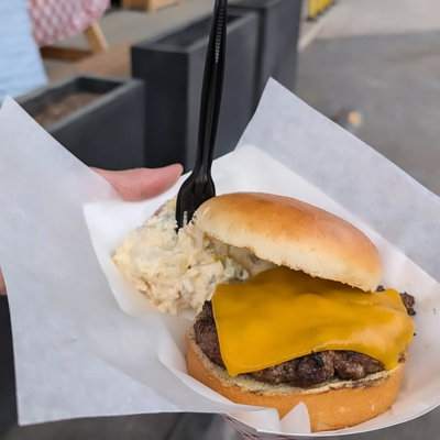 A Westside cheeseburger with cheddar and a side of potato salad